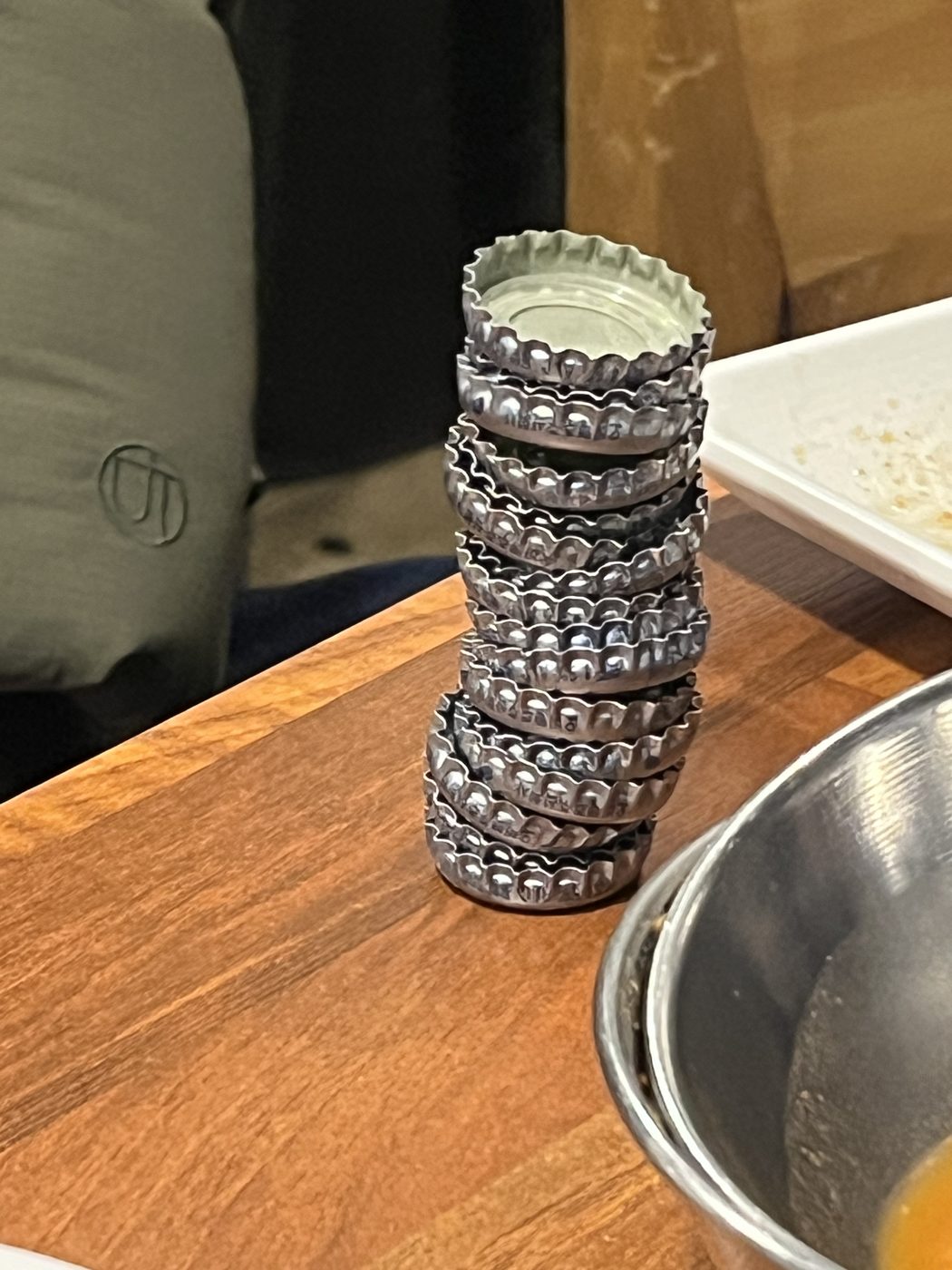 A tower of bottle caps, built over the course of dinner.